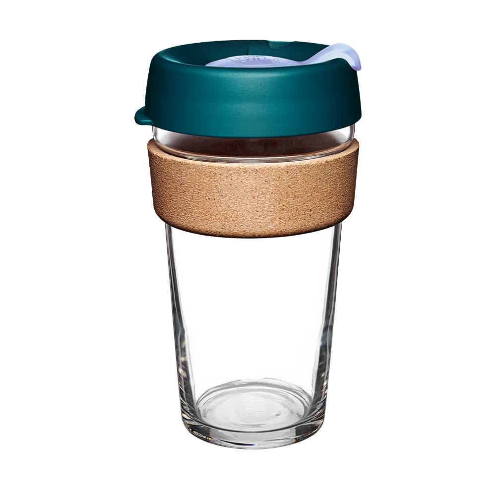 Clear glass reusable coffee cup with a teal lid and cork sleeve on a white background