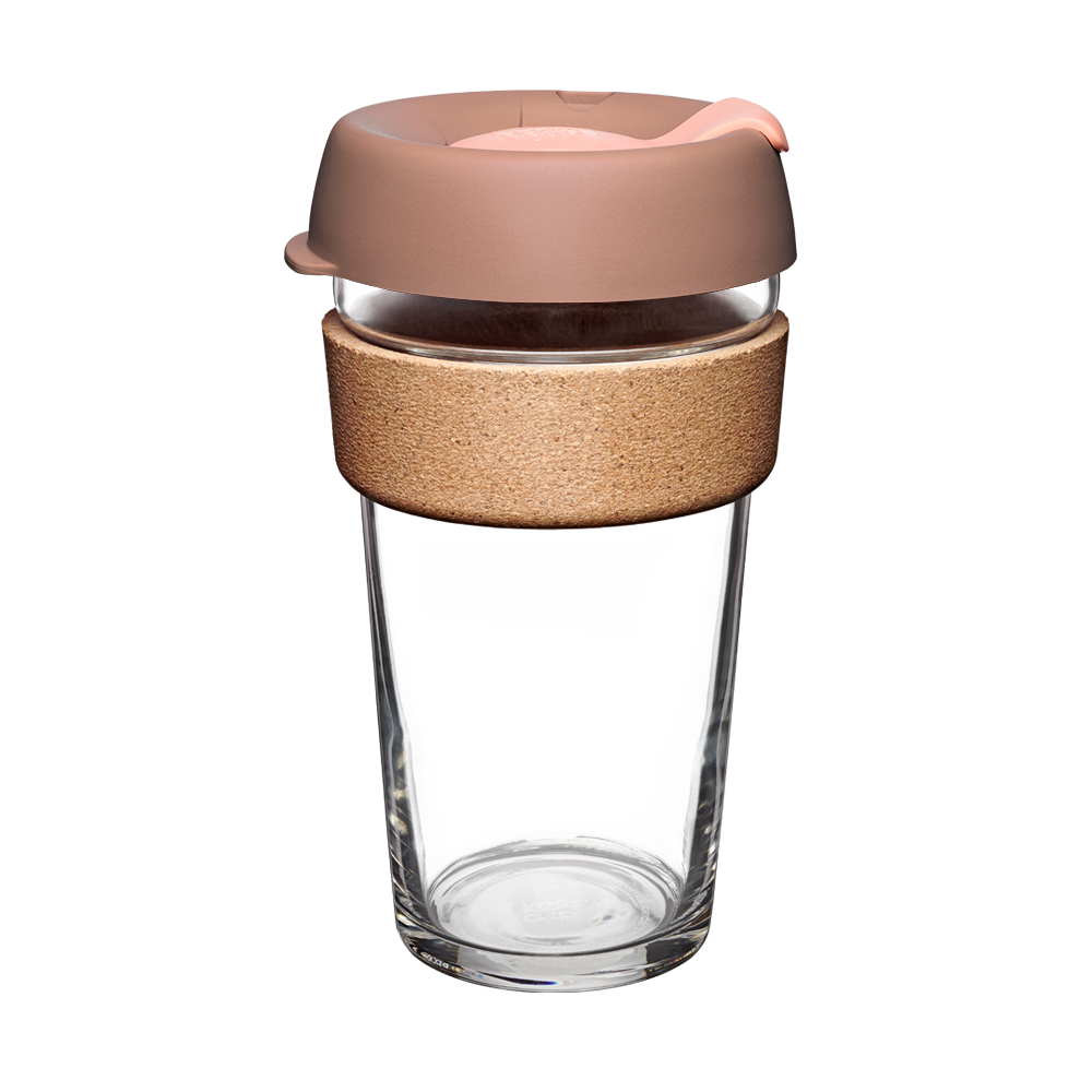 Clear glass reusable cup with a bronze coour lid and wooden sleeve on a white background