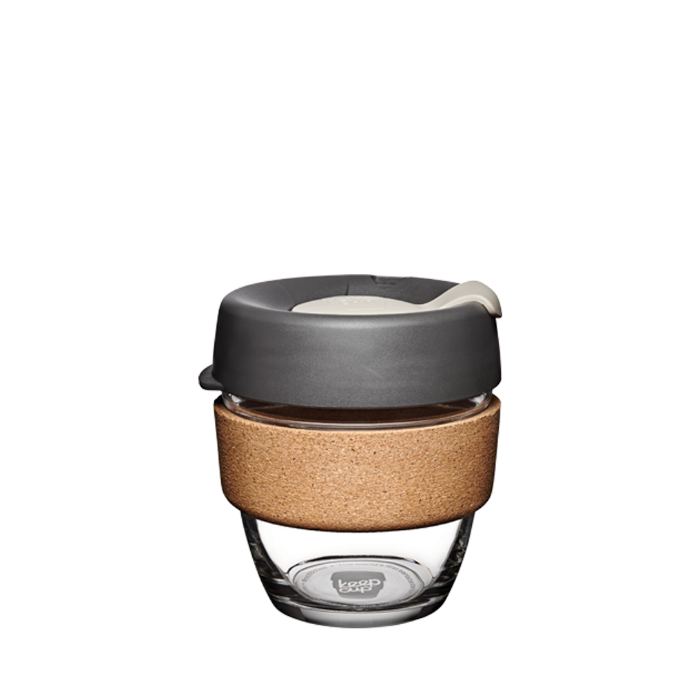 Reusable coffee cup with cork sleeve and gray lid on a white background