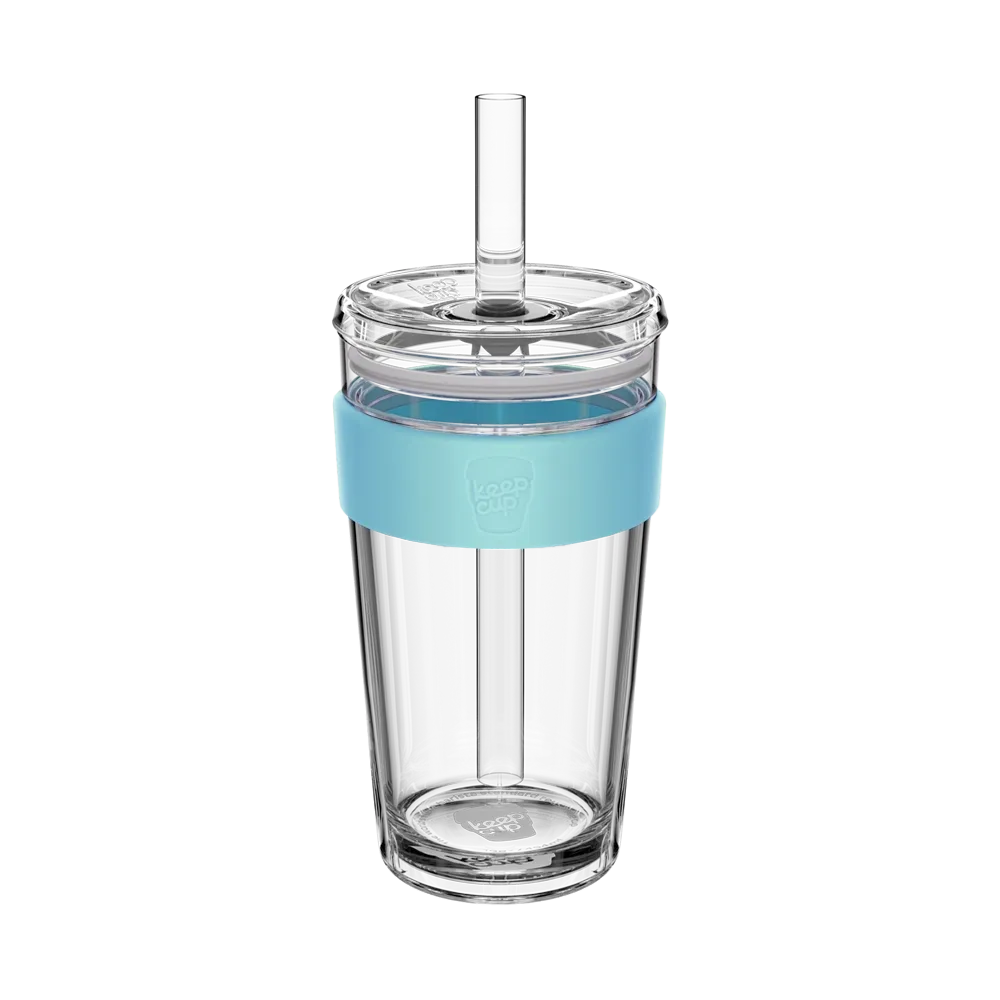 Clear tumbler with a blue sleeve and straw on a white background