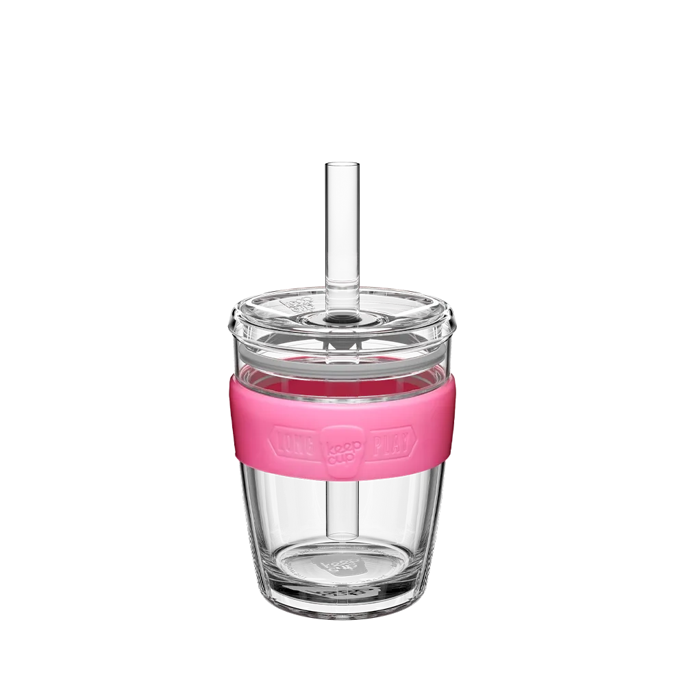 Clear tumbler with a pink base and straw on a white background
