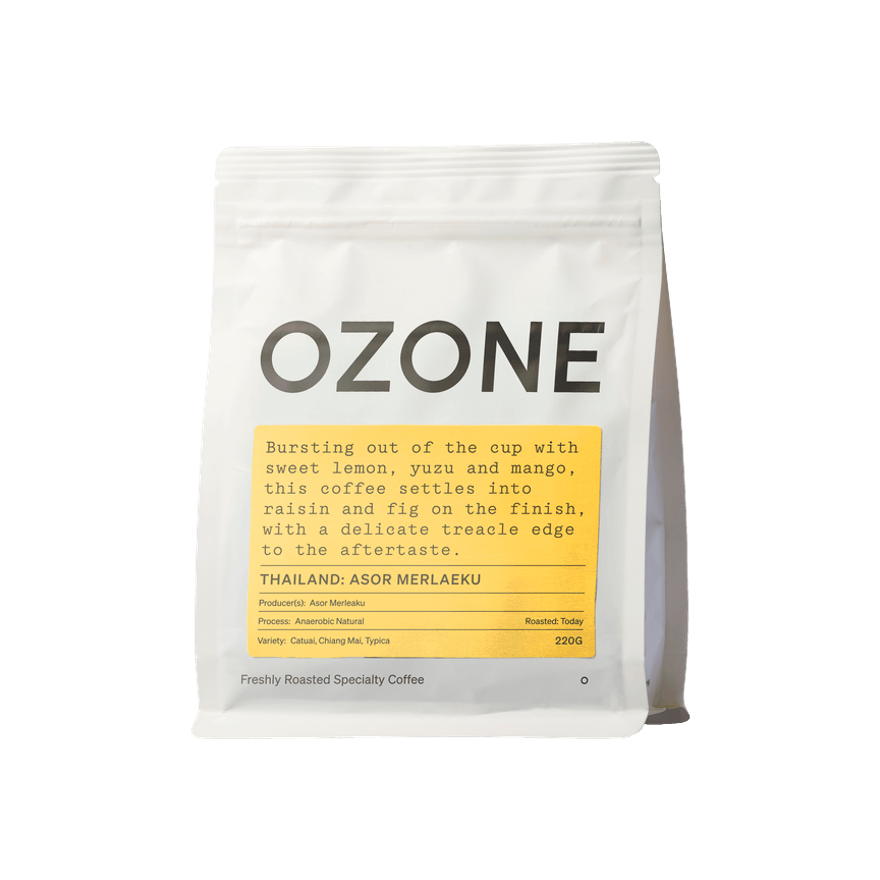 White 220g bag of Ozone Thailand Asor Merlaeku Anaerobic Natural specialty coffee, featuring a yellow label with tasting notes describing sweet lemon, yuzu, mango, raisin and fig flavours, shown front-facing against a plain background.