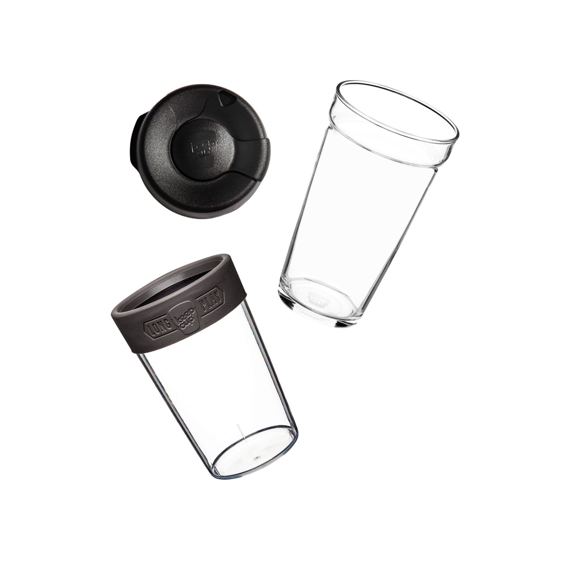 Flat lay showing the KeepCup Brew Longplay L 16oz disassembled into its components: sipper lid, clear glass cup, plastic outer sleeve and silicone band.