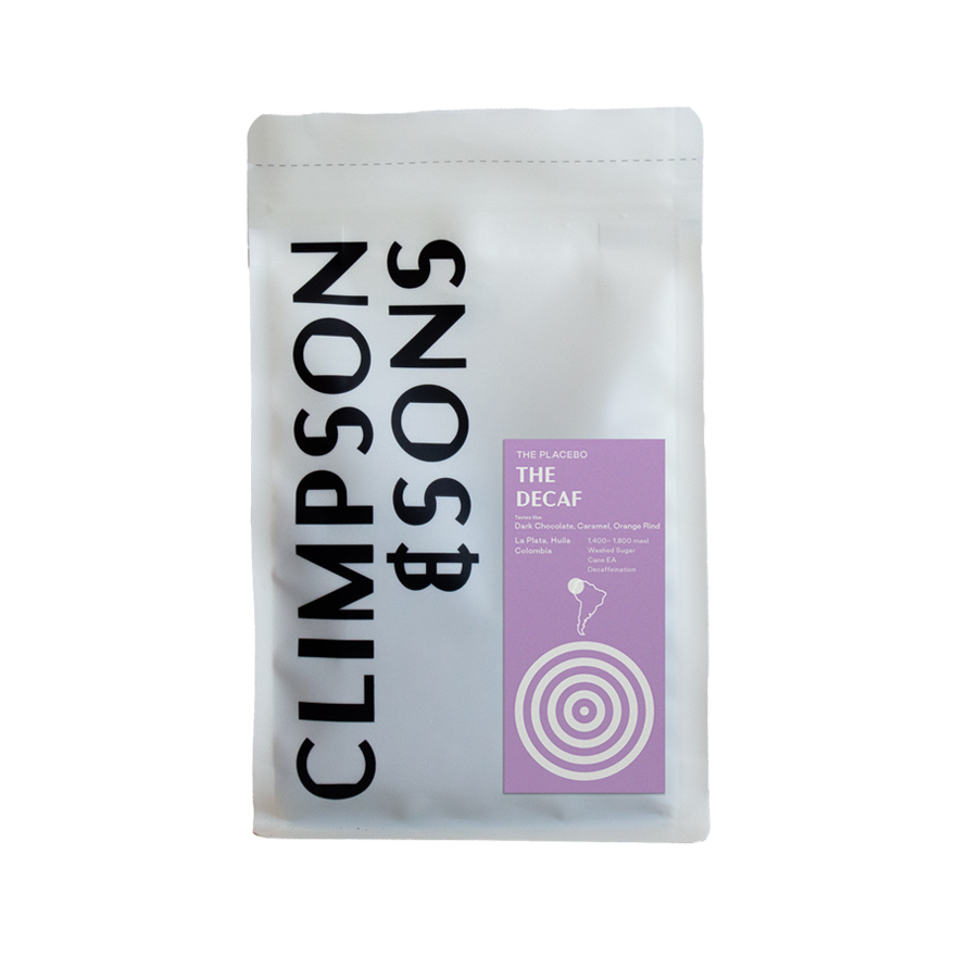 White coffee bag from Climpson & Sons featuring "The Placebo: The Decaf" label in purple, with tasting notes of dark chocolate, caramel and orange rind. La Plata Decaf 250g from Huila, Colombia.
