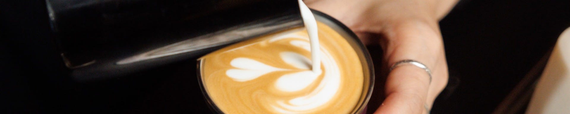 Barista pouring milk into KeepCup Thermal