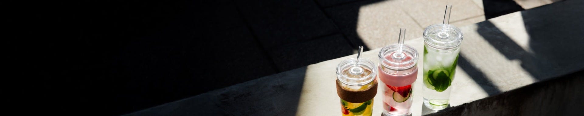 KeepCup Cold Cup Cork, Cold Cup Longplay and Cold Cup Original on bench with iced teas 