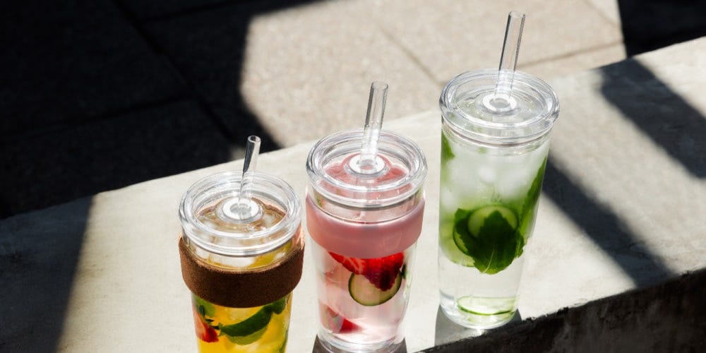KeepCup Cold Cup Cork, Cold Cup Longplay and Cold Cup Original on bench with iced teas 